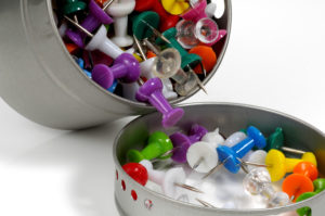 A round dish full of push pins.  Image Courtesy of DreamsTime.com.